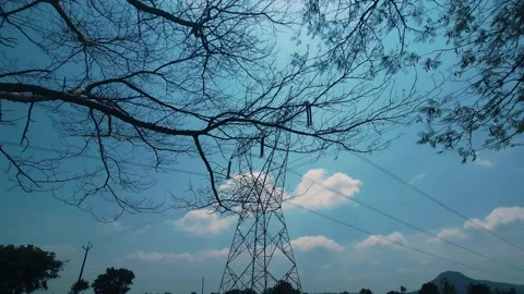 Lattice Electric Pylon Through Bare Autumn Branches: An industrial steel power t Video stock 346682471