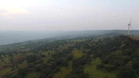 Lattice tower and modern wind turbines on green plateau in Satara India Stockbeeldmateriaal 336033685