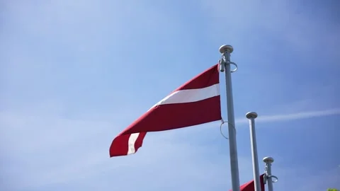 Latvian flag moving in the wind on flag pole Stock Footage 276725735