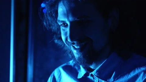 Laugh and cry -young man looks at old photos at the computer laughing and crying Stock Footage 149180576