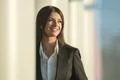 The laugh businesswoman stand near the column Photo