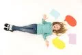 The laugh girl lay on the floor near the dialog signs. View from above Photo