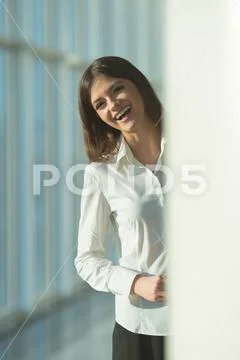 The laugh woman stand near the column Stock Photos