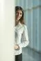 The laugh woman stand near the column Photo