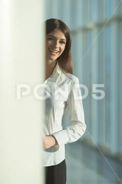 The laugh woman stand near the column Stock Photos
