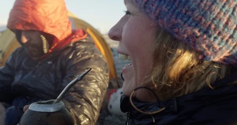 Laughing and drinking mate while camping Stock Footage 90405728