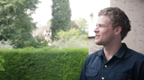 Laughing and drinking tea, a man is enjoying the nice day in his garden Stock Footage 40663085