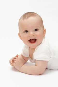 Laughing baby lying on the floor Stock-Fotos