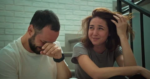 A laughing brunette guy with a beard in a white T-shirt talks and laughs with Stock Footage 280636747