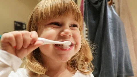 Laughing child brushing teeth Stock Footage 70605732