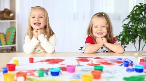 Laughing children look into the camera. They are painted in gouache. DOLLY HD Stock Footage