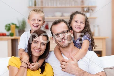 Laughing confident young family Stock Photos