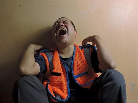 Laughing Construction Worker Sitting on the Floor Stock Photos