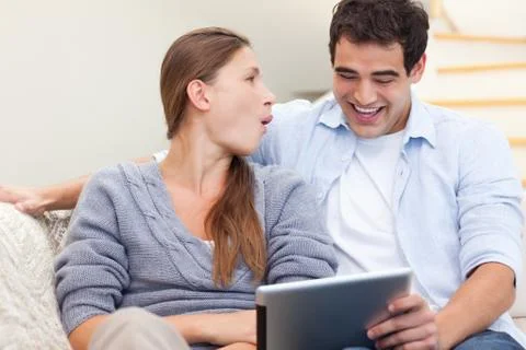 Laughing couple using a tablet computer Stockfoto's