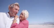 Laughing Elderly Couple On The Beach Together Stock Footage