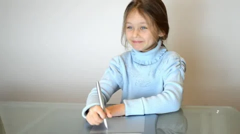 Laughing little girl drawing Stock Footage