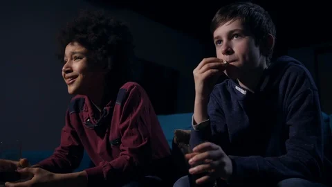 Laughing mixed race boy vs serious chewing friend Stock Footage 103872174