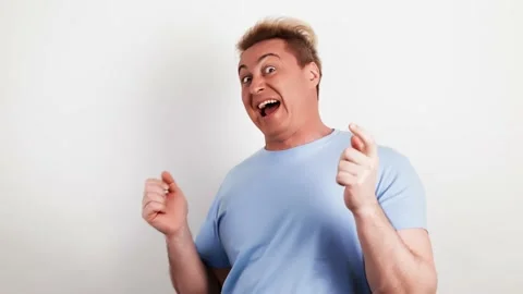 Laughing overjoyed man looking at camera. Smiling excited guy Stock Footage 235366851