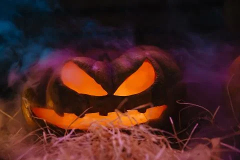 Laughing pumpkin with a candle inside Stock Photos