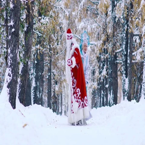 Laughing Snow Maiden having fun while playing with Father Frost Stockbeeldmateriaal 69707348