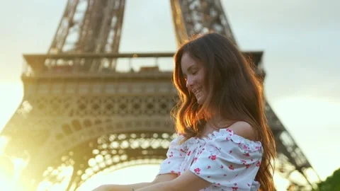 Laughing woman in front of Eiffel Tower at golden hour in Paris Stock Footage 313796925