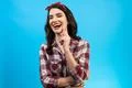 The laughing woman standing on the blue background Photo