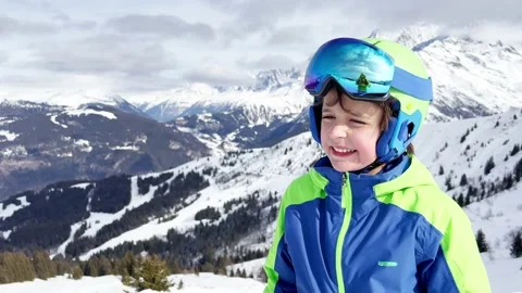 Laughing young boy in ski or snowboard outfit smiling portrait Vidéo 204866147