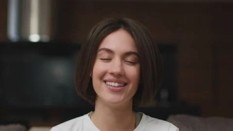 Laughing young girl watching TV comedy show, looking at camera, giggling Stock Footage 205457912