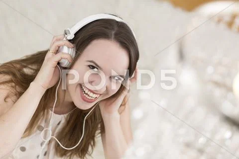 Laughing Young Woman Wearing Headphones