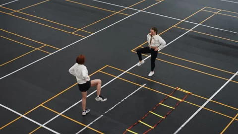 Laughter and light drills during urban rooftop badminton session. Two friends Stock Footage 341767574