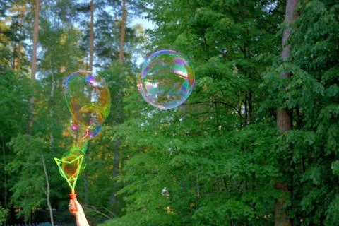 Launch of large multi-colored soap bubbles.	 Stock Photos