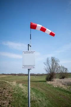 On  launch site for ballooning there is a wind vane and the sky is blue Stock Photos