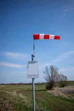 On  launch site for ballooning there is a wind vane and the sky is blue Stock Photos