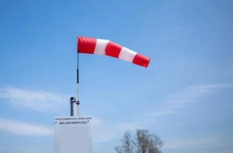 On  launch site for ballooning there is a wind vane and the sky is blue Stock Photos