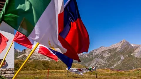 Laundry and flags in mountains. Clothes hanging to dry, flags waving in wind. Stock Photos