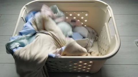 Laundry. Basket for dirty Laundry, the preparation for a big wash, top view. whi Stock Footage 130709235
