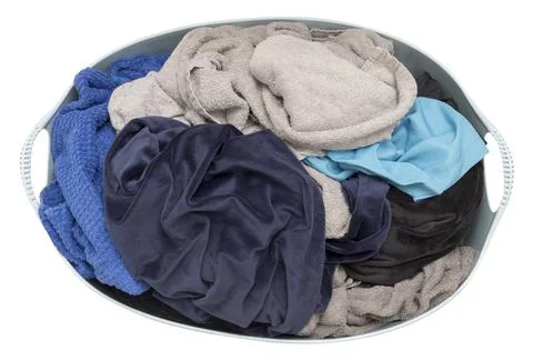Laundry basket filled with assorted clothes in various colors, isolated on wh Stock Photos