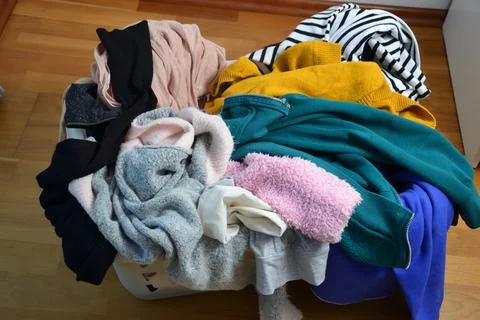 A laundry basket full of clothes Stock Photos