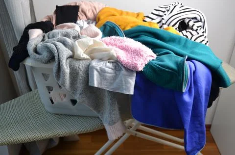 A laundry basket full of clothes Stock Photos
