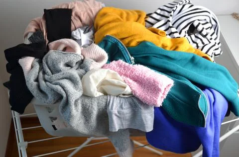 A laundry basket full of clothes Stock Photos