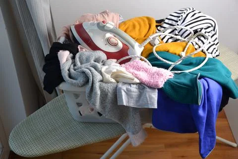 A laundry basket full of clothes Stock Photos