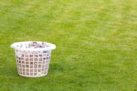 Laundry basket on lawn Stock Photos