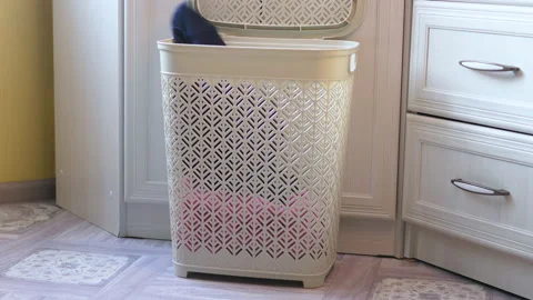 Laundry basket put dirty clothes for washing in home interior.everyday chor.. Stock Footage 232356498