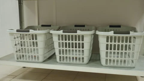 Laundry Baskets on Shelf in Organized Cleaning Facility Stock Footage 318847109