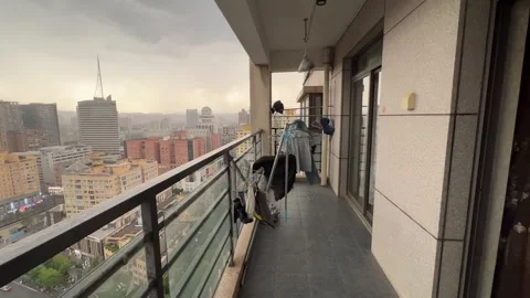Laundry blown off the lines from a balcony in the rain, China Stock Footage 341667820