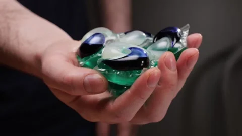 Laundry capsules for washing machine close-up. capsule contains concentrated Stock Footage 269452675