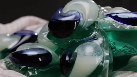 Laundry capsules for washing machine close-up. capsule contains concentrated Stock Footage 269452870