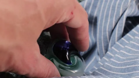 Laundry capsules for washing machine close-up. capsule contains concentrated Stock Footage 270009826