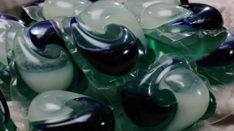 Laundry capsules for washing machine close-up. capsule contains concentrated Stock Footage 270010287
