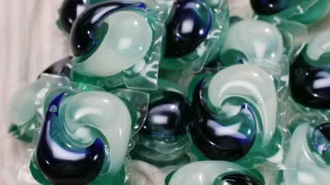 Laundry capsules for washing machine close-up. capsule contains concentrated Stock Footage 270010369